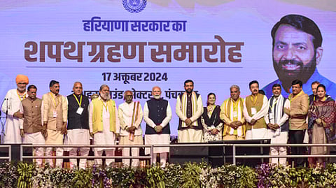 Prime Minister Narendra Modi with Haryana Governor Bandaru Dattatreya, CM Nayab Singh Saini and others during the swearing-in ceremony on October 17.