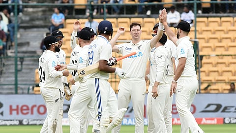 New Zealand's Matt Henry celebrate with teammates after taking the wicket of Indias R Ashwin during the second day of the first Test cricket match between India and New Zealand, at M Chinnaswamy Stadium, in Bengaluru.