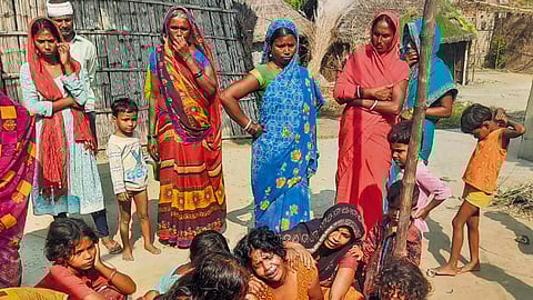 Family members mourn the death of hooch tragedy victims, in Saran district, Thursday, Oct. 17, 2024.