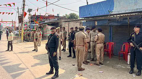Security personnel stand guard outside a mosque in a violence-affected area, at Maharajganj in Bahraich district, Uttar Pradesh.