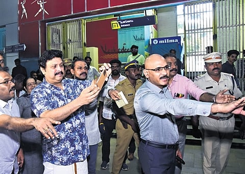 Minister K B Ganesh Kumar launches the Citizen Sentinal App by clicking the pic of a car parked in a non-parking zone before KMRL office in Kochi