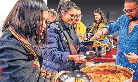 Sri Vamsi Matta shares food with the audience following a performance
