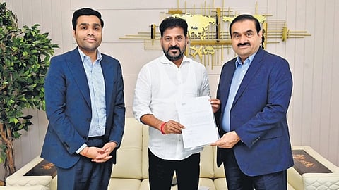 Adani Group chairman Gautam Adani hands over a cheque worth Rs 100 crore as a donation to the Young India Skill University, to Chief Minister A Revanth Reddy
in Hyderabad on Friday