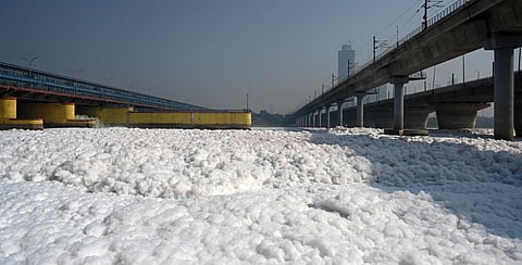 Toxic foam floats on the surface of the polluted Yamuna River, at Kalindi Kunj, in New Delhi on Saturday.