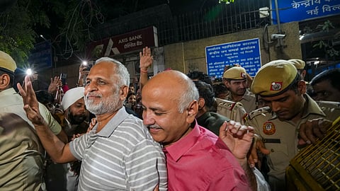 AAP leader and former Delhi health minister Satyendar Jain (L) with party leader Manish Sisodia greets supporters after being released from the Tihar Jail, in New Delhi, Friday, Oct. 18, 2024.
