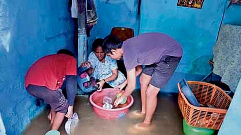 Residents in their flooded house.
