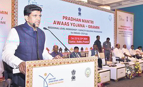 Union Minister Pemmasani Chandra Sekhar addressing a gathering during the PM Awaas Yojana Gramin regional level workshop in Guntur on Monday