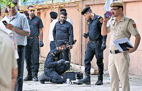 National Security Guard personnel inspect the blast site outside the CRPF school
at Prashant Vihar in Rohini area of New Delhi on Sunday morning