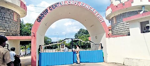 A cop stands guard at the entrance while Rachakonda police along with bomb detection squad conduct search operations at the CRPF school in Jawaharnagar on Tuesday