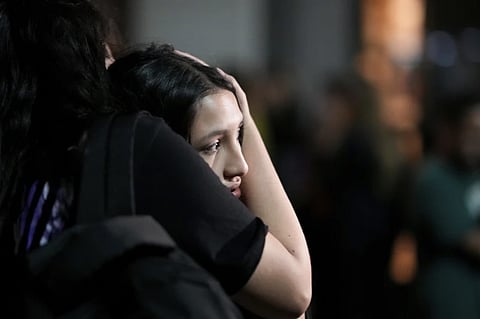 People embrace outside the hotel where former One Direction singer Liam Payne was found dead after he fell from a balcony in Buenos Aires, Argentina, Wednesday, Oct. 16, 2024.