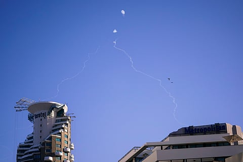 Israel's Iron Dome anti-missile system fires to intercept as air raid sirens sound in Tel Aviv.