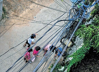 Tangled cables tied to an electric pole at Nayapalli in Bhubaneswar