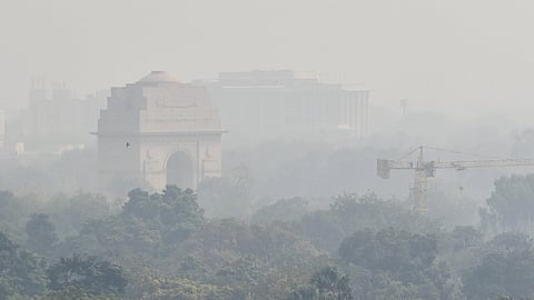 A view of India Gate covered with thin layer of smog, in New Delhi on Tuesday.