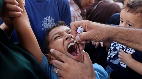 A health worker administers the polio vaccine to a Palestinian child in Zawayda, Gaza in September 2024.