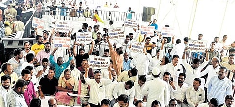 Villagers raise slogans during the public hearing on cement factory Wednesday
