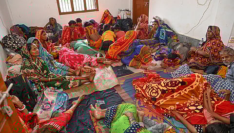 Evacuated villagers rest at a cyclone shelter ahead of the cyclone 'Dana' landfall, in Odisha's Bhadrak district.