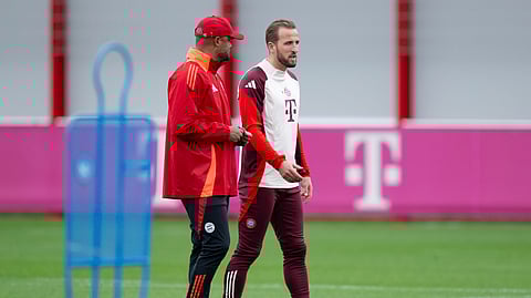 Bayern's Harry Kane, right, and head coach Vincent Kompany attend a training session, a day before the Champions League opening phase soccer match against Barcelona in Spain, at the Säbener Street training ground in Munich, Germany.
