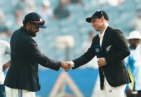 India's captain Rohit Sharma and New Zealand's captain Tom Latham during the toss before the start of the second test cricket match between India and New Zealand, at the Maharashtra Cricket Association Stadium, in Pune, Thursday, Oct. 24, 2024.