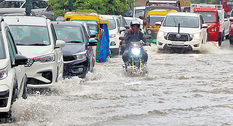 Vehicles wading through a flooded road at Chakkai on Friday