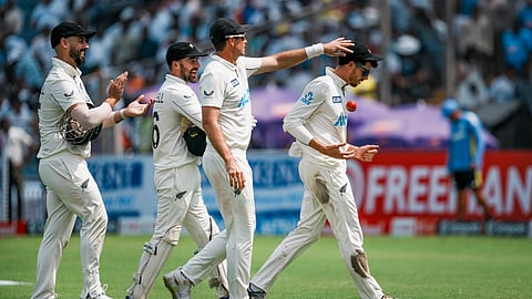 New Zealand's Mitchell Santner, 3rd from left, gestures after taking a seven-wicket haul during the second day of the second test cricket match between India and New Zealand
