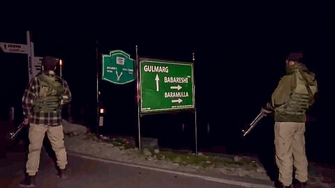 Security personnel stand guard after a terror attack in which fourincluging two Army soldiers were killed, in Gulmarg.