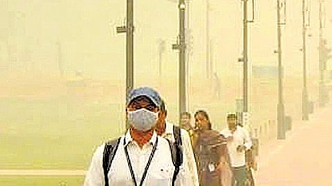 People wear mask to walk through streets of Delhi amid air pollution surge.