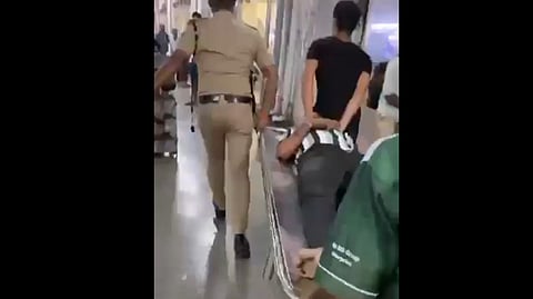 Police rescue one of the injured persons following a stampede in Bandra railway station in Mumbai on Sunday.