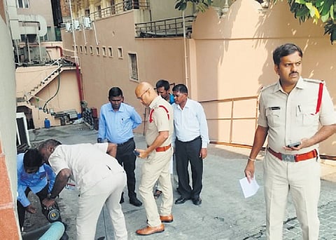 Tirupati police conducting searches at a hotel after a bomb threat.