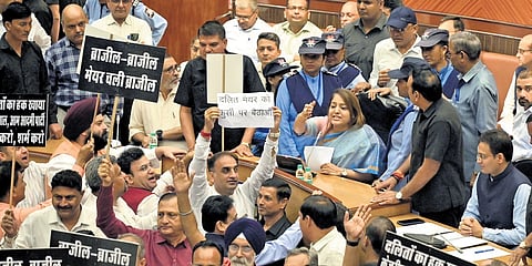 BJP councillors protesting over various issues in MCD House on Monday.