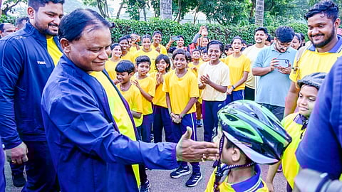 Odisha Chief Minister Mohan Manjhi interacts with a young participant of the 'Run for Unity'