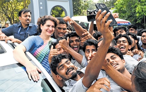 Congress candidate Priyanka Gandhi poses for a selfie with the students of WMO Arts and Science College at Muttil in Wayanad on Monday