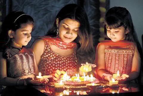 A family in Mattancherry lights up diyas