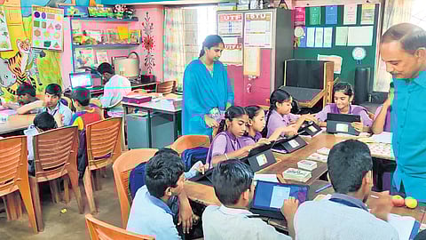 Specially-abled students are seen reading using tabs.