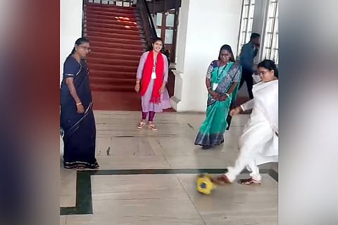CPIM coucillors protesting against the privatisation of football turf by passing around a football at the Ripon building.