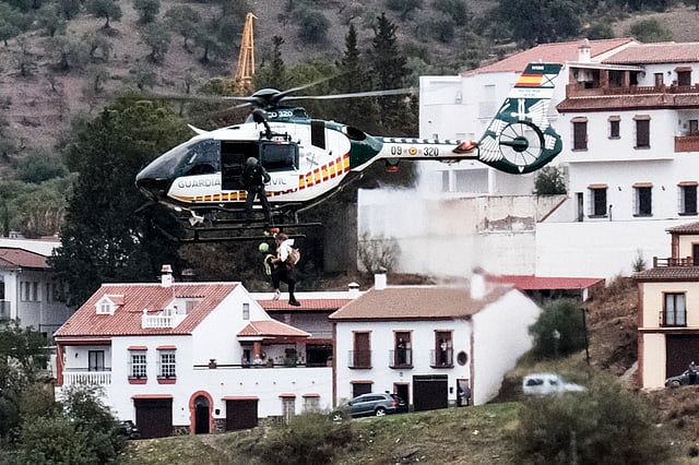 Emergency teams rescue a person who was stranded by the water in a Guardia Civil helicopter, after the floods preceded by heavy rains that caused the overflow of the river in the town of Alora, Malaga, Spain.