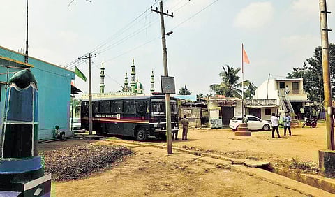 A police platoon stands guard at Kadakol village in Haveri district on Thursday