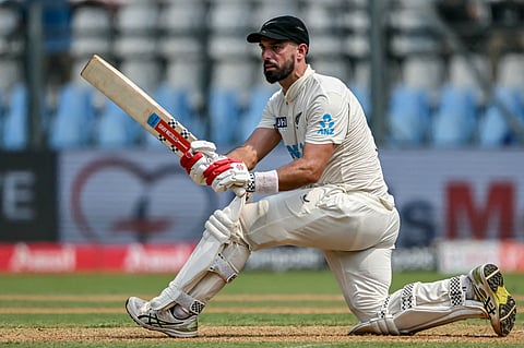 Daryl Mitchell plays a shot on the first day of the third Test between India and New Zealand in Mumbai (Photo | AFP)