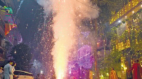 People burst firecrackers during Diwali festival on Thursday night
