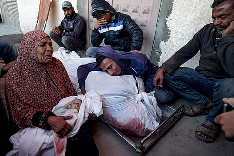 Palestinians mourn their relatives killed in the Israeli bombardment of the Gaza Strip at a hospital morgue in Deir al-Balah, Friday, Nov. 1, 2024.