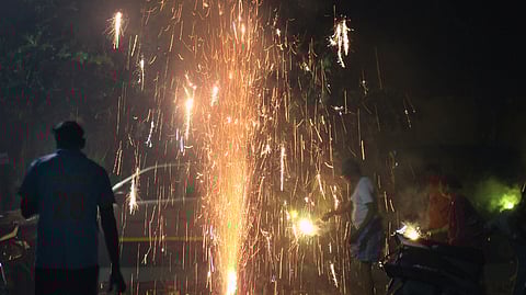 People and children burning fire crackers to celebrate the festival of light Deepavali.