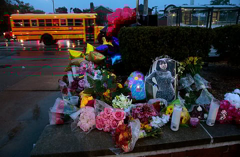 A photo of Alexandria Bell rests at the scene of a growing floral memorial to the victims of a school shooting at Central Visual & Performing Arts High School, Oct. 25, 2022, in St. Louis.