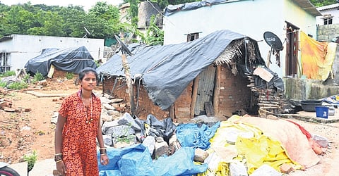 A woman near her thatched-roof hut in the Iruliga Tribal Colony, located just 3 km from the deputy commissioner’s office in Ramanagara
