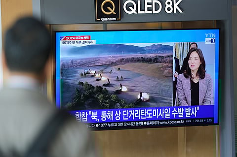 A TV screen shows a report of North Korea's multiple short-range ballistic missiles with file footage during a news program at the Seoul Railway Station in Seoul, South Korea.