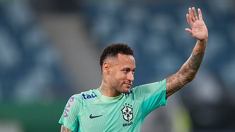 Brazil's Neymar waves to fans during a training session in Cuiaba, Brazil.