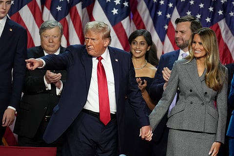 Republican Presidential nominee former President Donald Trump holds hands with former first lady Melania Trump after speaking to supporters at the Palm Beach County Convention Center during an election night watch party, Wednesday, Nov. 6, 2024