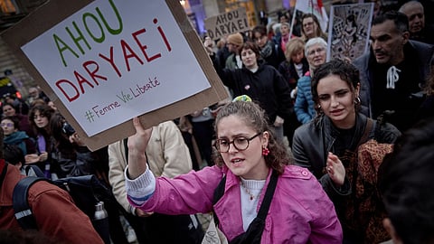 Women take part in a protest gathering called by the "Woman Life Freedom Collective" (Femme Vie Liberte) and the Association Phenix, in support of the Iranian student arrested after stripping to her underwear in Tehran, by the Pantheon monument near the Sorbonne University in Paris on November 5, 2024.