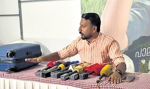 Rahul Mamkootathil with the blue trolley bag at the UDF election committee office in Palakkad on Wednesday
