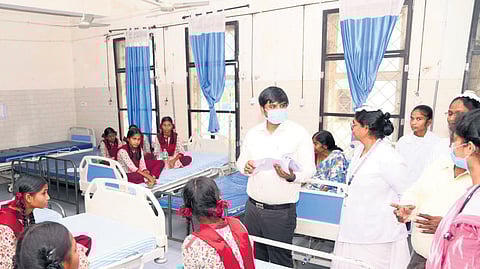 District Collector Kumar Deepak enquires with doctors about the health condition of the students at a hospital in Mancherial.