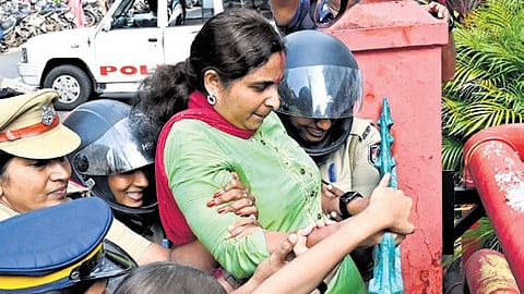 Police personnel prevent a Mahila Congress worker from scaling the Secretariat wall on Wednesday during the outfit’s protest against the raid in Palakkad