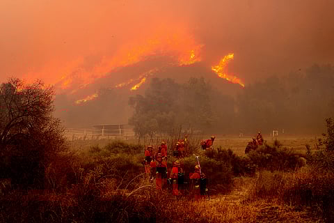 Inmate firefighters battle the Mountain Fire at Swanhill Farms in Moorpark, Calif., on Thursday, Nov. 7, 2024.